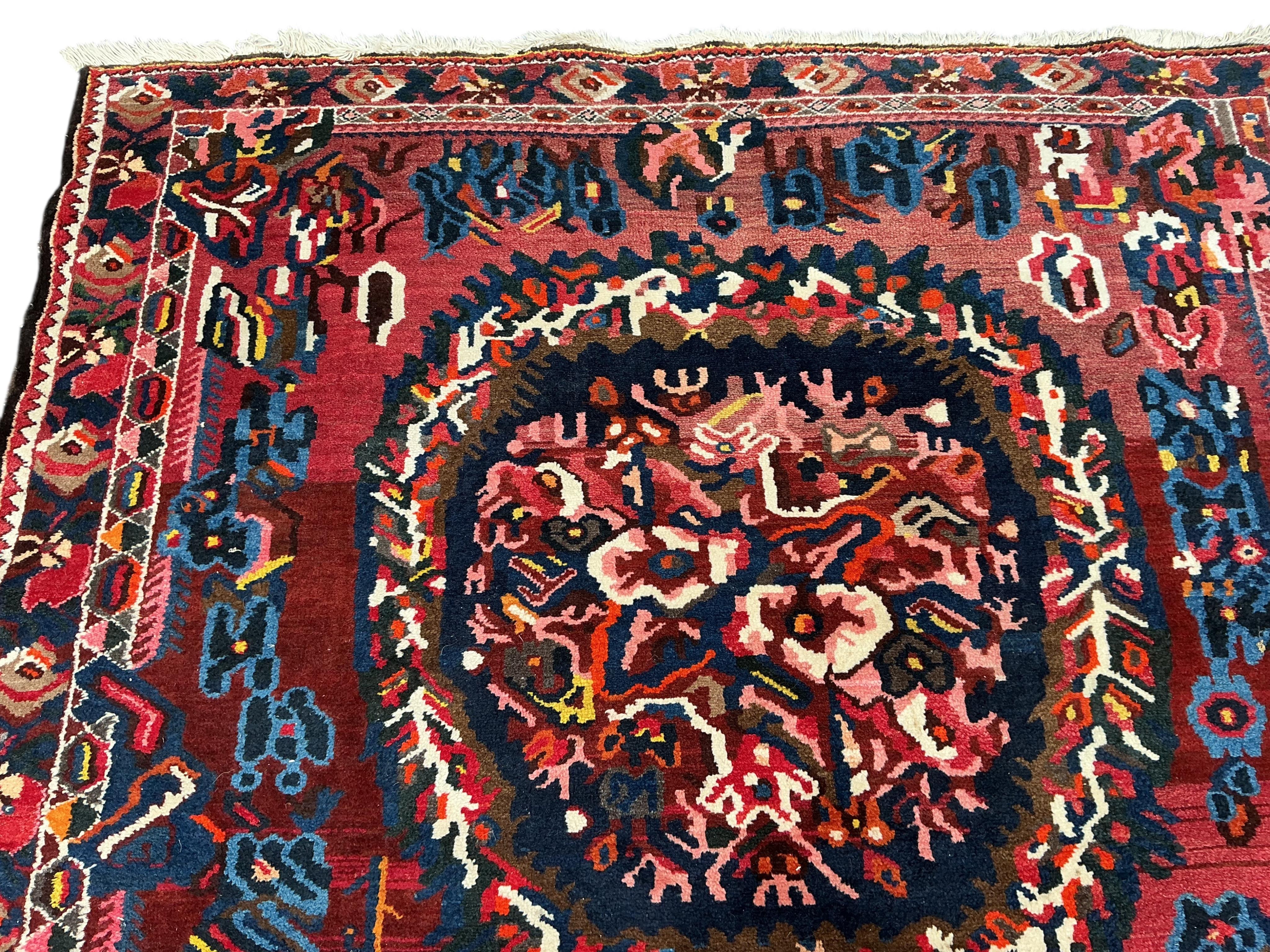 A Baktiari red ground carpet, 390 x 170cm